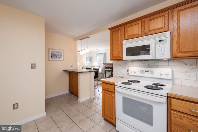 kitchen featuring white appliances, brown cabinets, backsplash, and light tile patterned floors