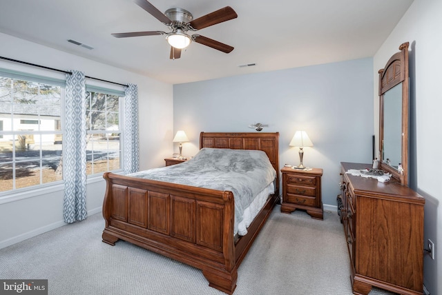 bedroom featuring light carpet, a ceiling fan, visible vents, and baseboards