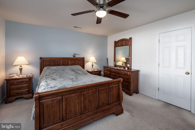 bedroom featuring a ceiling fan, light carpet, visible vents, and baseboards