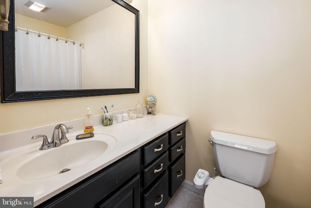 bathroom with toilet, vanity, visible vents, and tile patterned floors