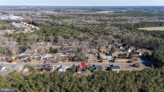 birds eye view of property featuring a view of trees