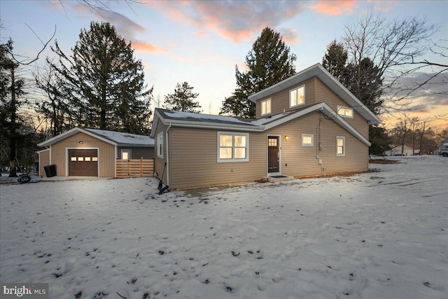 view of front of property with a garage and an outbuilding