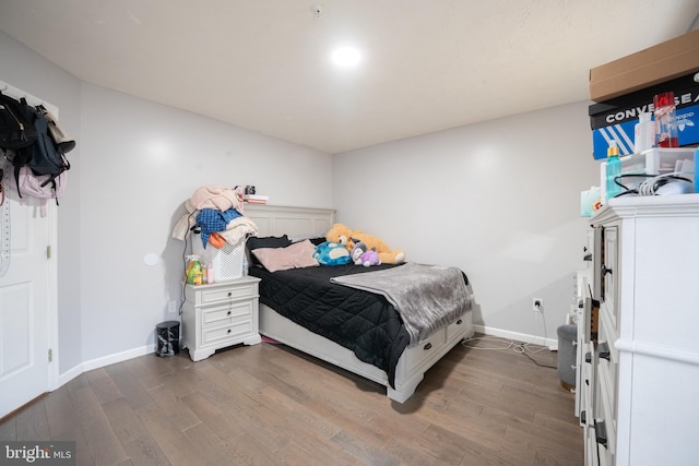 bedroom with dark hardwood / wood-style floors