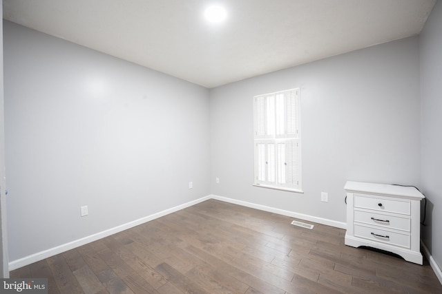 spare room with dark hardwood / wood-style floors