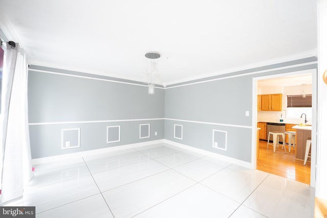 tiled spare room with ornamental molding