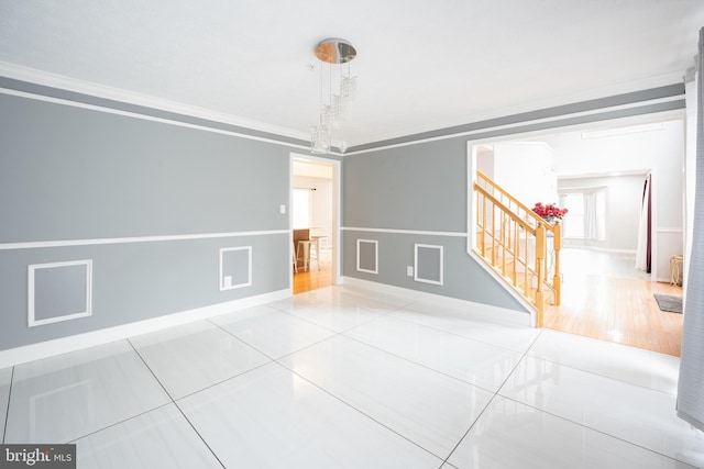 tiled spare room featuring crown molding