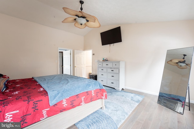 bedroom featuring vaulted ceiling, ceiling fan, and light wood-type flooring