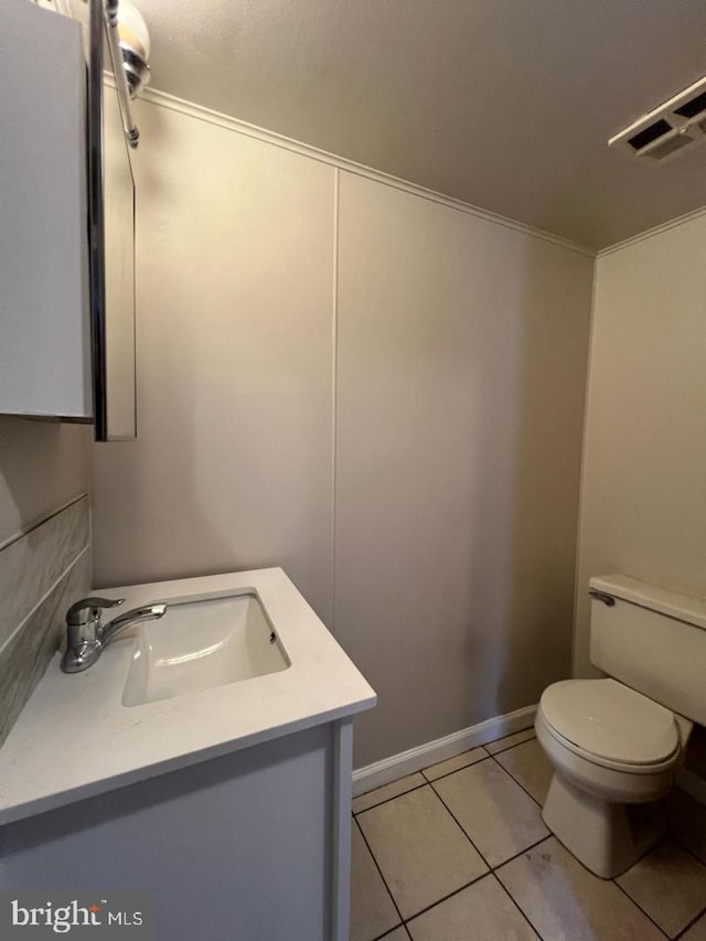 bathroom with vanity, toilet, and tile patterned flooring