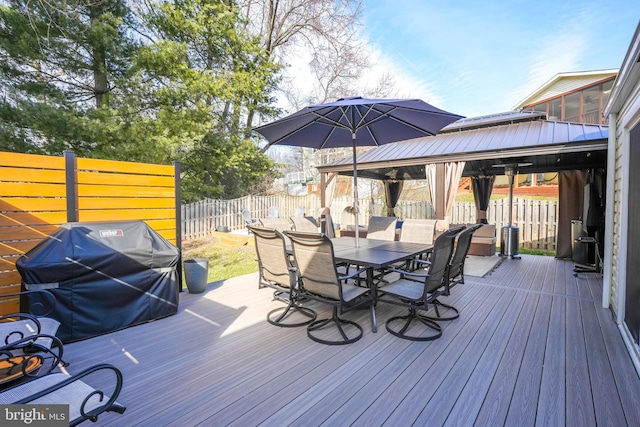 wooden deck featuring grilling area and a gazebo