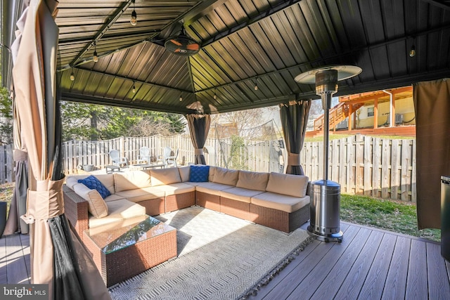 wooden deck with an outdoor hangout area and a gazebo