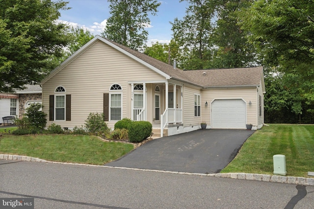 ranch-style house featuring a garage and a front lawn