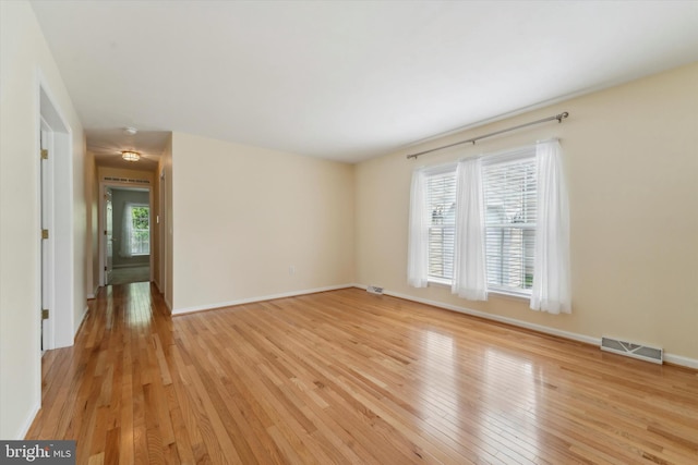 empty room with light hardwood / wood-style floors