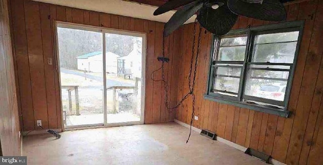 empty room featuring wooden walls