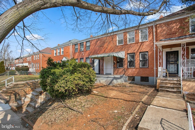 townhome / multi-family property featuring brick siding