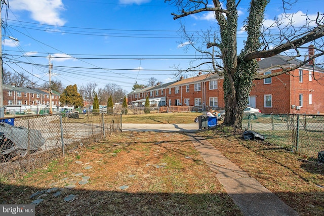 view of yard featuring a residential view and fence