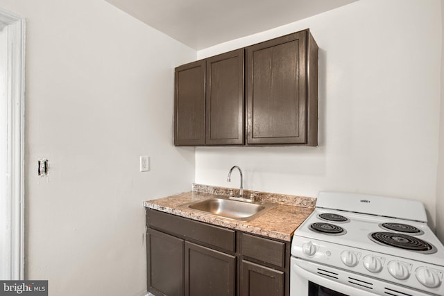 kitchen featuring light countertops, electric range, a sink, and dark brown cabinetry