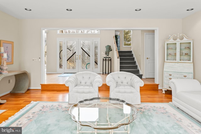 living area with recessed lighting, stairway, baseboards, and wood finished floors