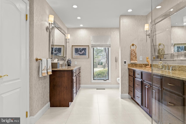 bathroom with wallpapered walls, recessed lighting, visible vents, and vanity