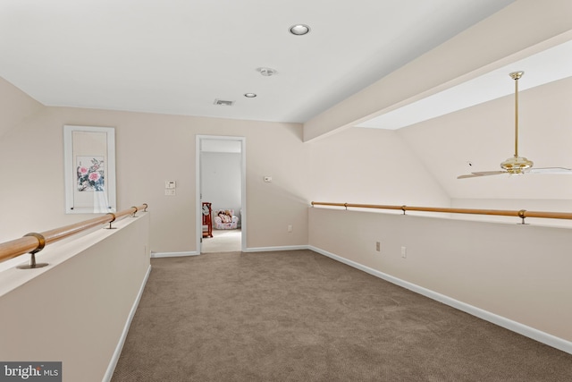 empty room with carpet, vaulted ceiling with beams, recessed lighting, visible vents, and baseboards