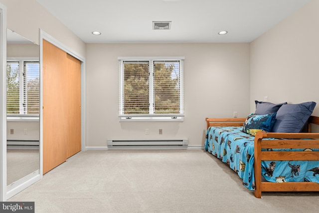 bedroom with recessed lighting, visible vents, baseboard heating, and light colored carpet