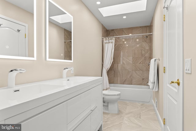 full bathroom featuring shower / bath combination with curtain, a skylight, a sink, and toilet