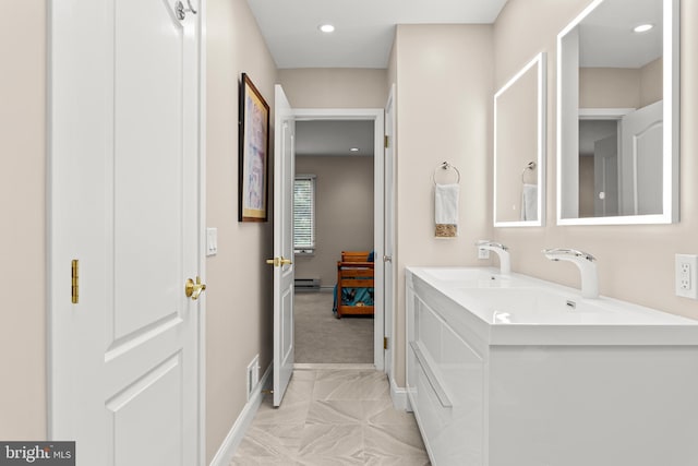 full bath featuring double vanity, a sink, visible vents, and baseboards