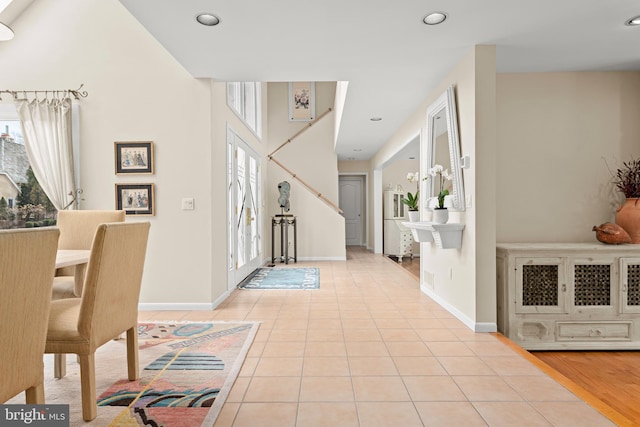 foyer entrance with light tile patterned floors, baseboards, and recessed lighting