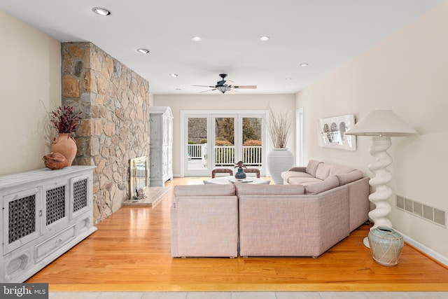 living area with visible vents, a ceiling fan, light wood-style flooring, a fireplace, and recessed lighting