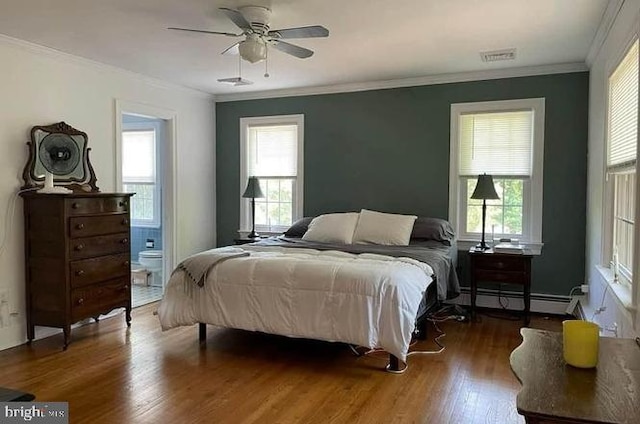 bedroom featuring connected bathroom, a baseboard radiator, ceiling fan, crown molding, and dark wood-type flooring