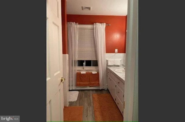 bathroom with vanity and wood-type flooring