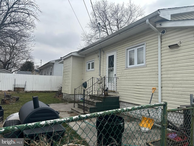 back of house with a fenced backyard