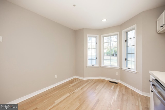 unfurnished dining area with light hardwood / wood-style flooring