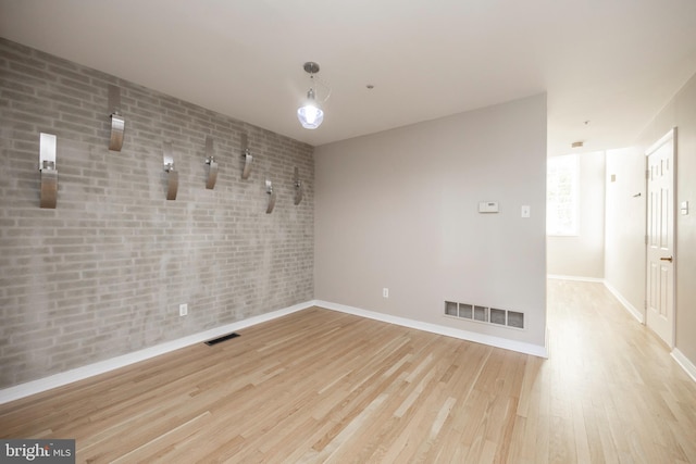 empty room with light hardwood / wood-style floors