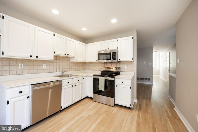 kitchen featuring white cabinetry, sink, and stainless steel appliances