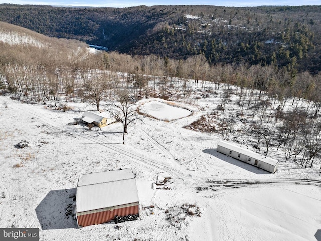 snowy aerial view with a mountain view