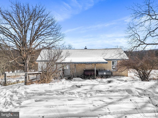 view of snow covered back of property