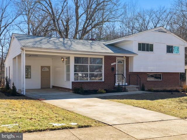 split level home featuring a carport and a front yard