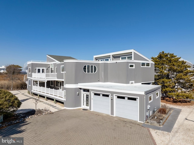 view of front of house with a garage and a balcony