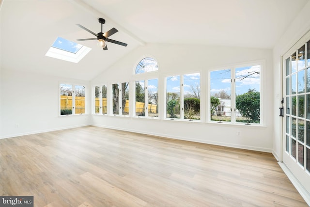 unfurnished sunroom with vaulted ceiling with skylight and ceiling fan