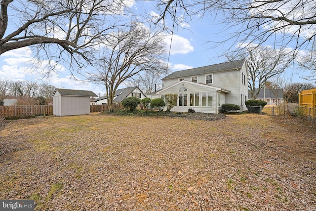 exterior space with a storage shed, a fenced backyard, and an outdoor structure