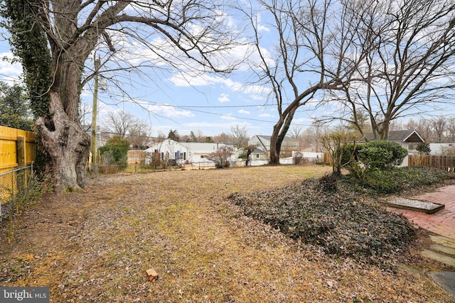 view of yard with a residential view and fence