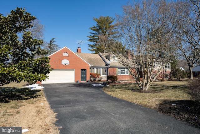 cape cod-style house with a garage and a front yard