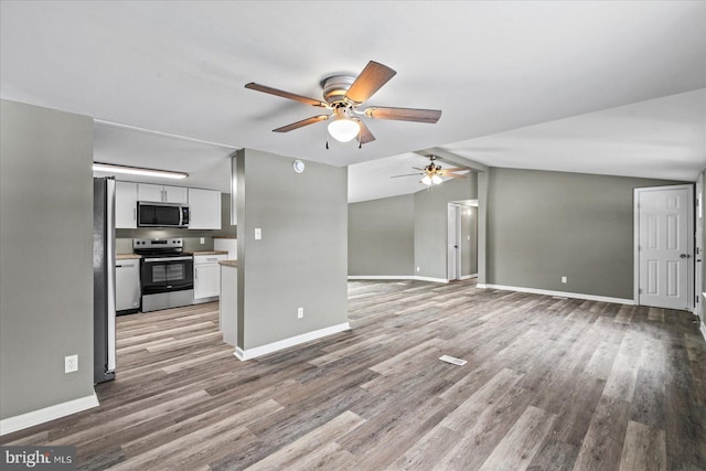 unfurnished living room featuring vaulted ceiling, ceiling fan, and light wood-type flooring