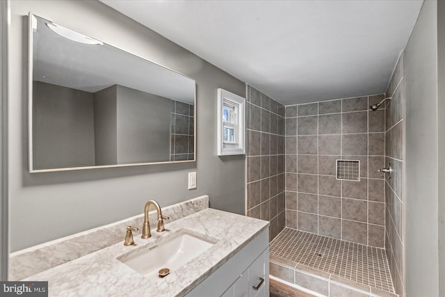 bathroom featuring vanity and a tile shower