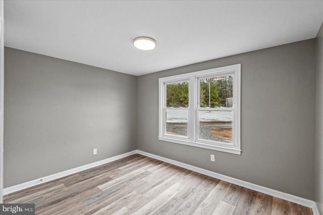 spare room with light hardwood / wood-style flooring