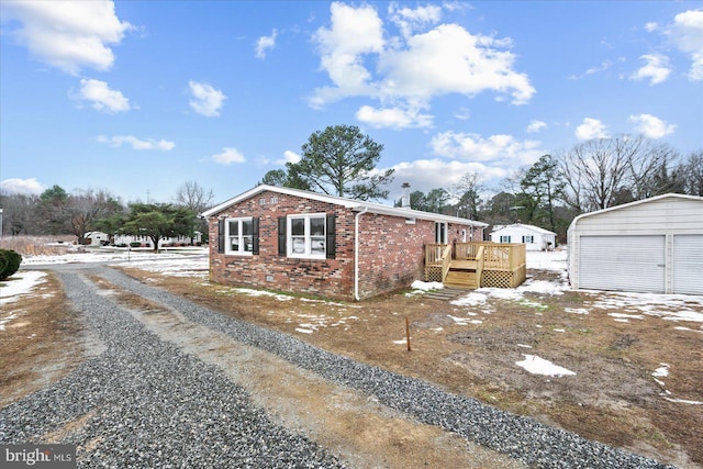 view of side of property featuring an outbuilding, a garage, and a deck