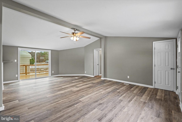 unfurnished living room with ceiling fan, lofted ceiling with beams, and hardwood / wood-style floors