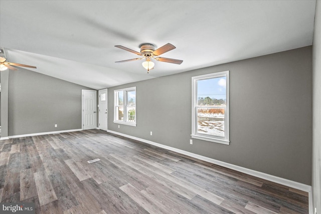 unfurnished room with hardwood / wood-style flooring, ceiling fan, and vaulted ceiling