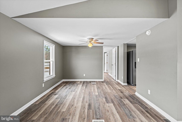 unfurnished room featuring ceiling fan and hardwood / wood-style floors