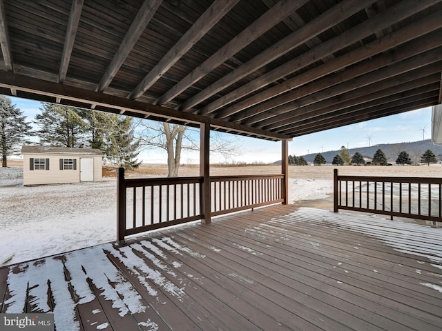 wooden terrace featuring an outbuilding